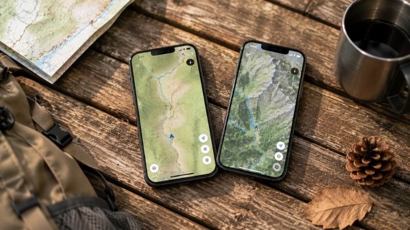 Two smartphones side by side showing different hiking navigation map apps for an AllTrails vs Gaia GPS comparison